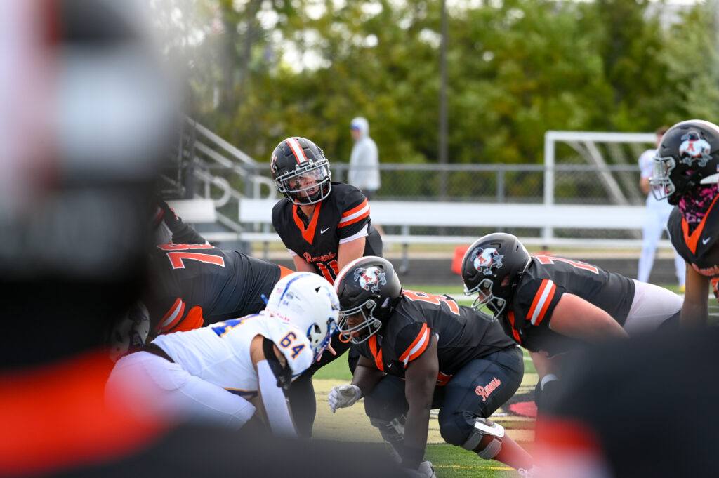 AU Footballers and opponents face off