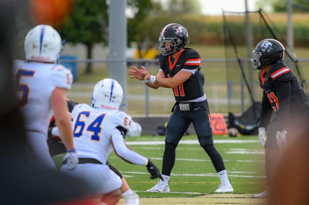 AU Footballer holds his hands out to catch the ball