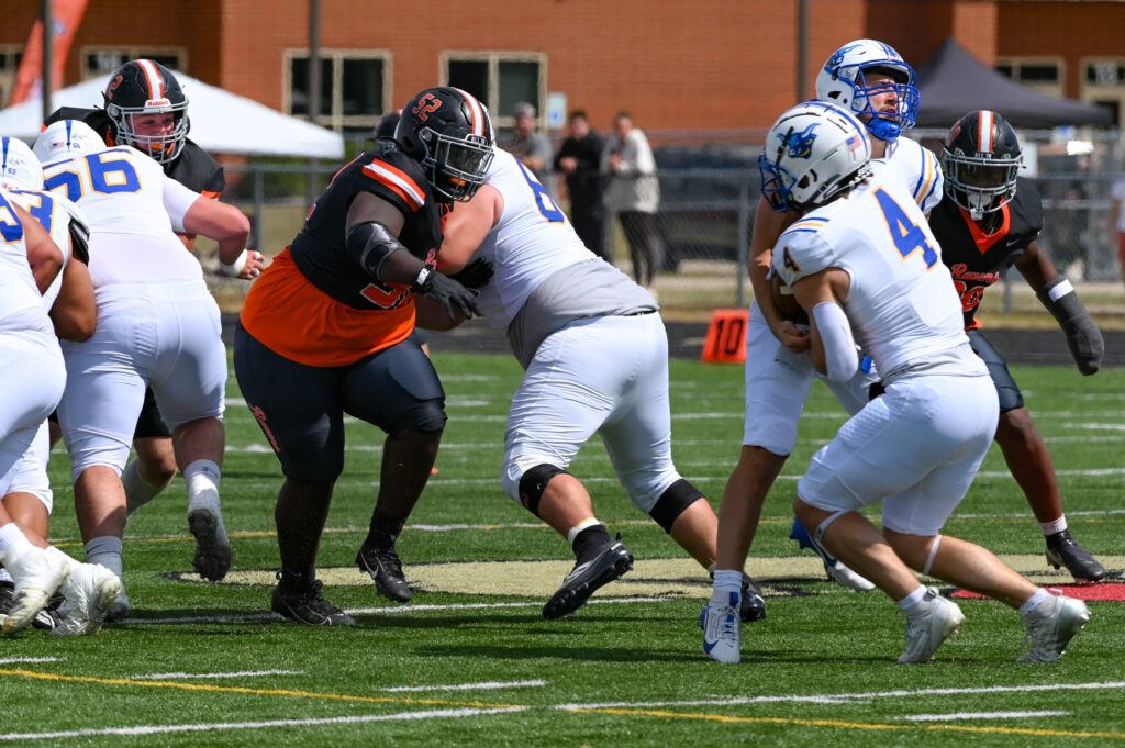AU Footballers wrestle against opponents