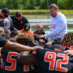 Coach prays over the AU Football team