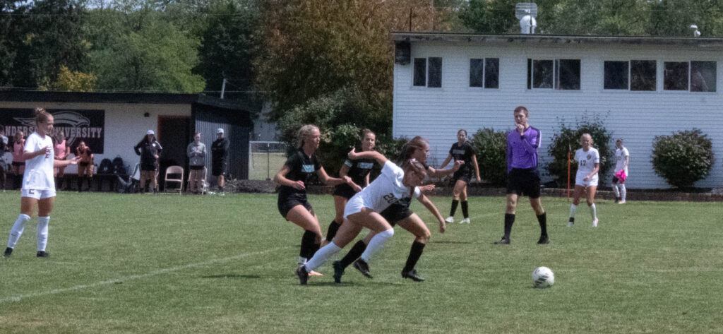 AU soccer player no. 20 fights to get the soccer ball