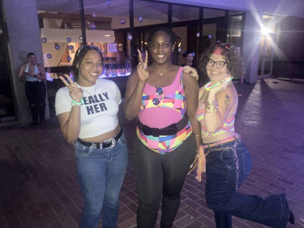 Three students giving the peace sign
