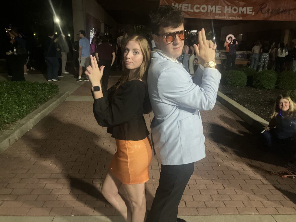 Two students doing the Charlie's Angels pose