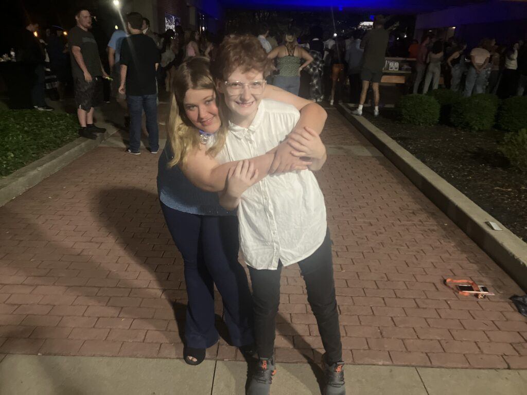 Two friends hugging and smiling