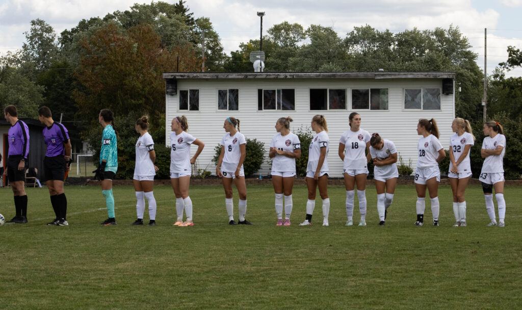 Au Soccer team lines up before the match