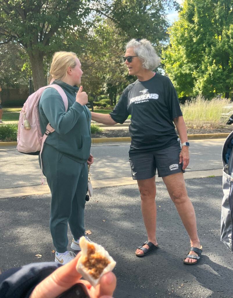 Sheryl talks with another student