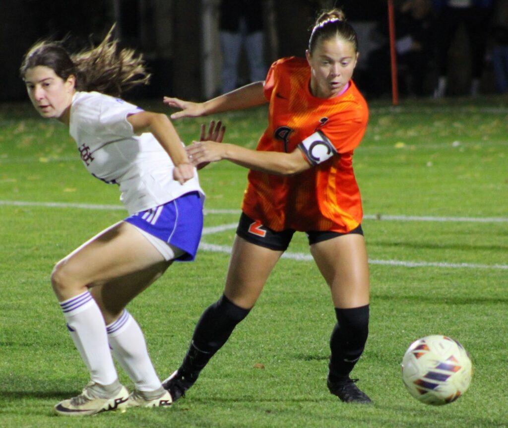 Hannah Thompson (2) racing to get the soccer ball