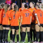 AU women's soccer team in a huddle