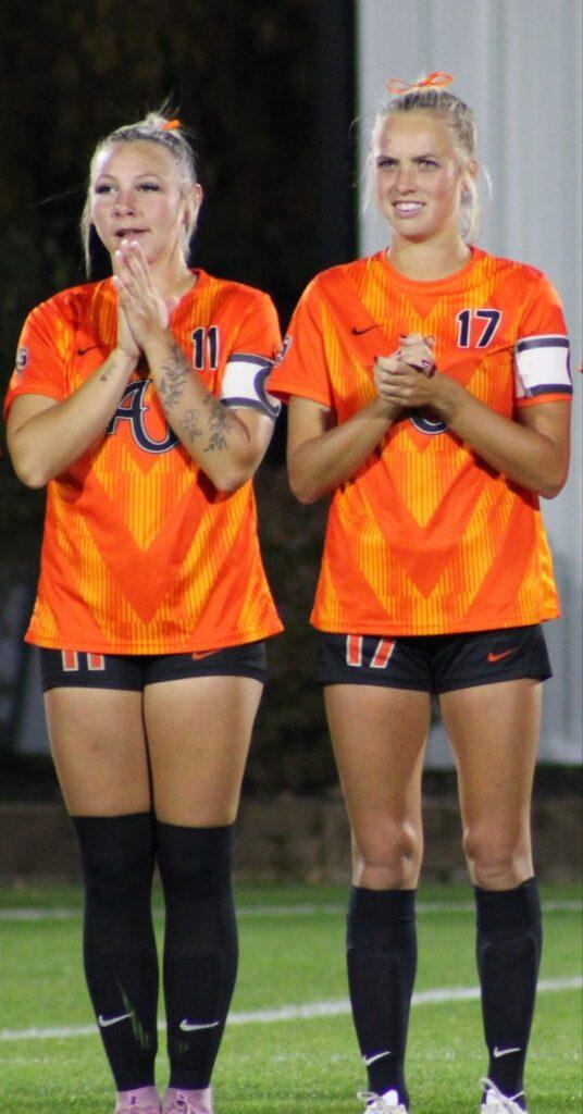 Meghan Foster (11) and Caroline Hill (17) standing together 