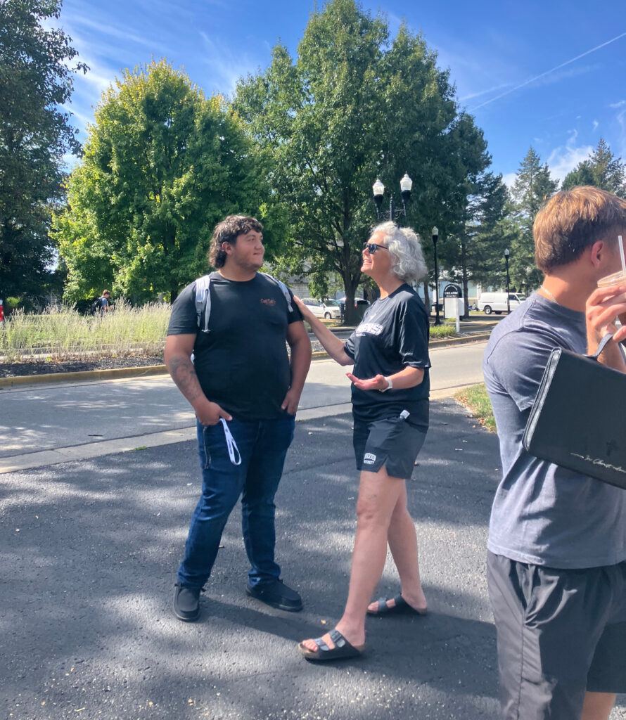 Sheryl talks with a  student outside