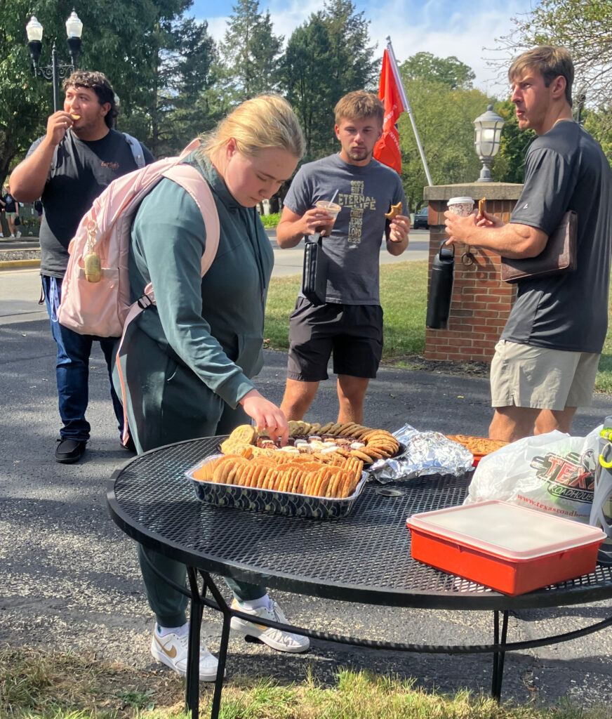 A student takes cookies from the table 